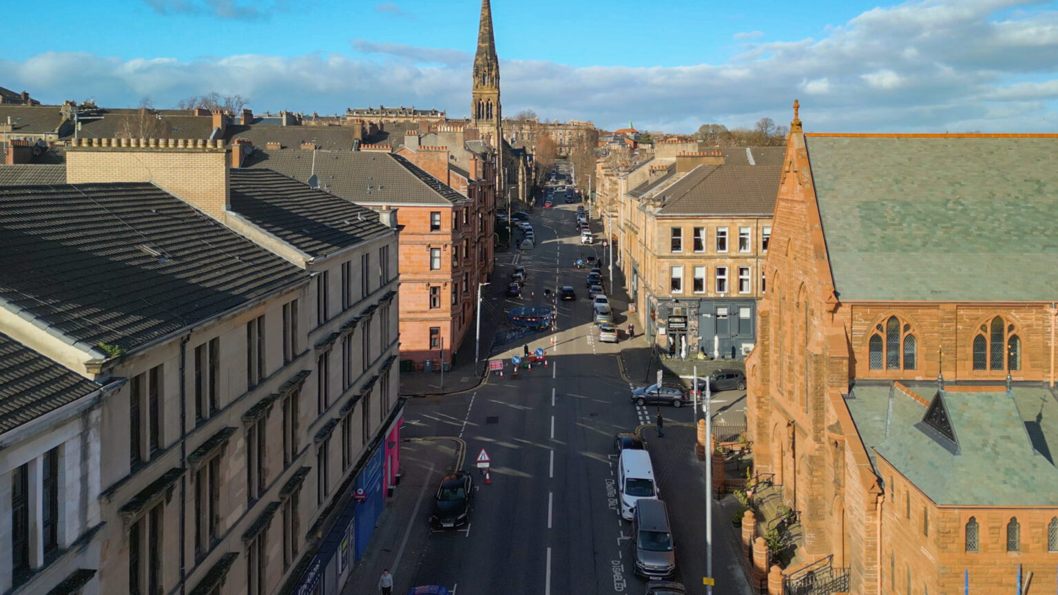 Hyndland Street, Partick, Glasgow, parked cars, roadworks, red sandstone church
