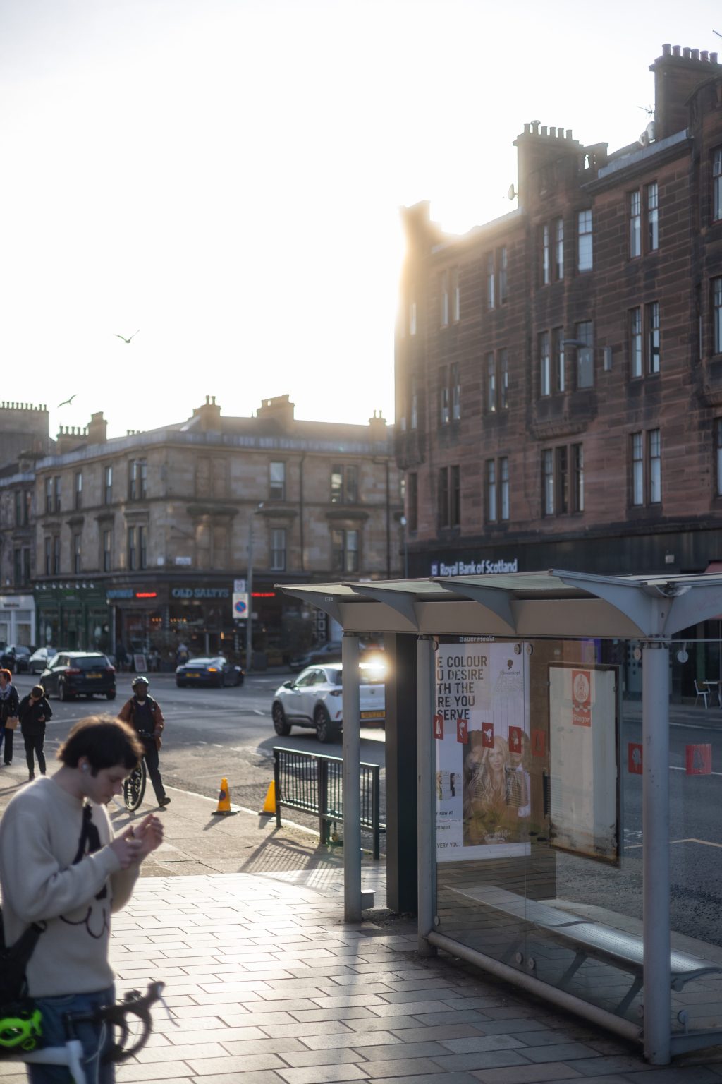 Byres Road, Hillhead, Glasgow, Bus shelter, pedestrians and cars on a sunny day