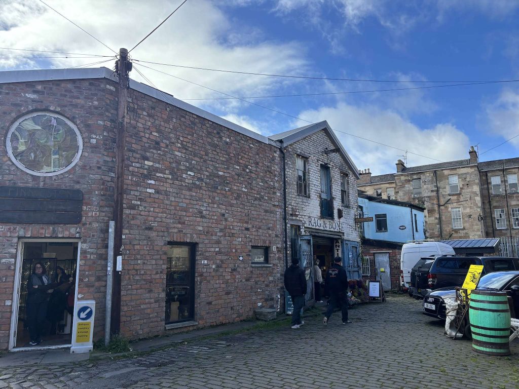 The Hidden Lane, Finnieston, Glasgow, a cobbled lane with brick studios, the Rag & Bone shop and people walking