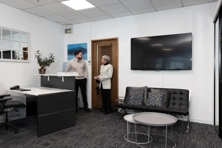 Two members of the Infiniti Properties team at reception in the Glasgow office