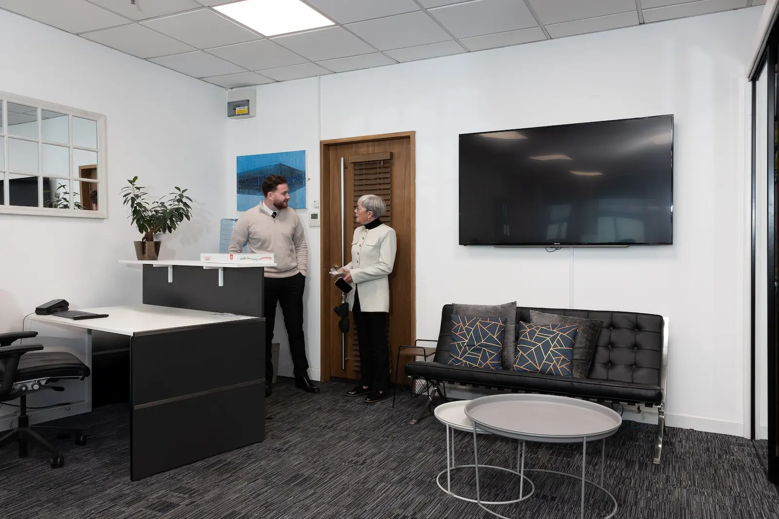 Two members of the Infiniti Properties team at reception in the Glasgow office